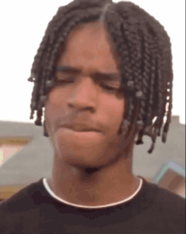 Young Man With Braids Making Funny Face