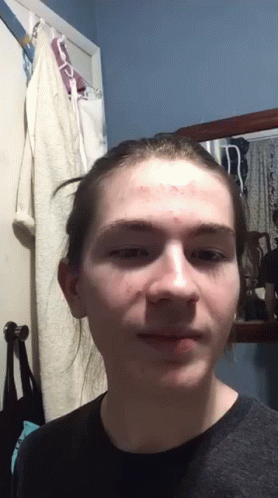 Young Man With Bun Looking at Camera