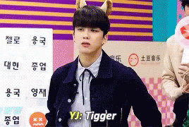 Young Man with Cat Ear Headband in Front of YJ Tigger Sign