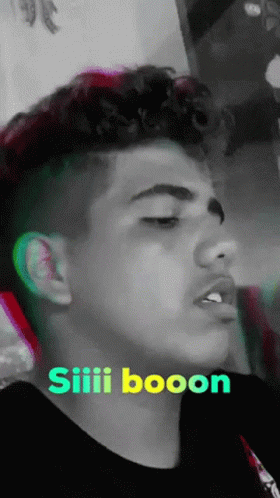 Young Man With Curly Hair in Black Shirt Saying Siiii Booon