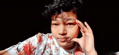 Young Man With Curly Hair Making Funny Face Hand to Ear