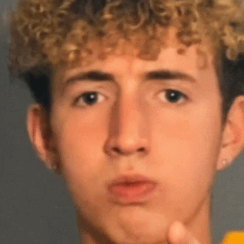 Young Man With Curly Hair Making Funny Face GIF
