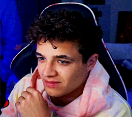 Young Man With Curly Hair Sitting GIF