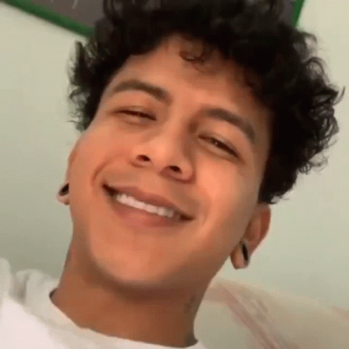 Young Man With Curly Hair Smiling Eyes Closed Mouth Open