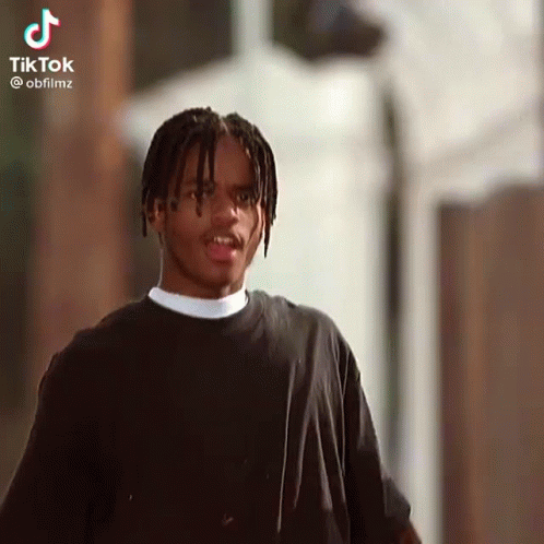 Young Man With Dreadlocks Looking at Camera