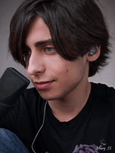 Young Man With Ear Buds And Mary 13 Black Shirt GIF