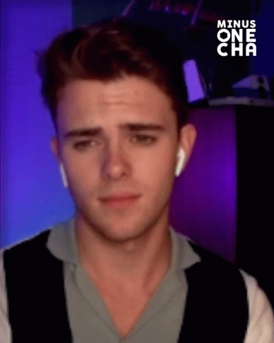 Young Man With Ear Buds Making Funny Face