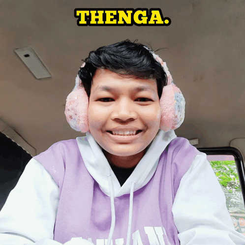 Young Man With Ear Warmers and Purple Shirt Saying Thenga