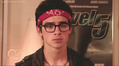 Young Man With Glasses And Bandana In Front Of Level 5 Poster GIF