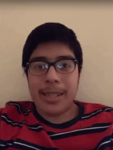 Young Man With Glasses And Mustache In Red And Black Shirt GIF