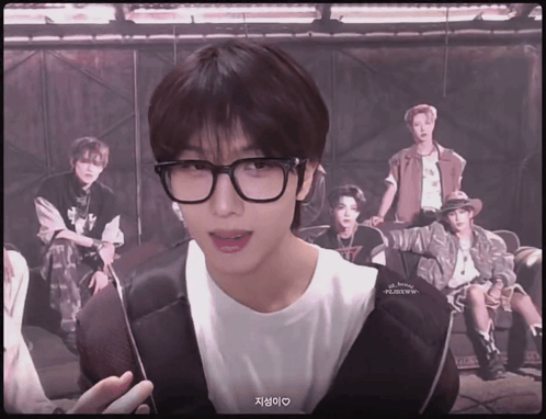 Young Man With Glasses in Front of Young Men