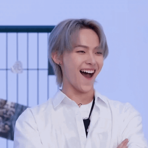 Young Man With Gray Hair and White Shirt Clapping