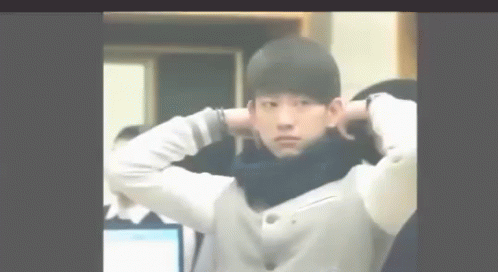 Young Man With Hands Behind Head And Scarf GIF