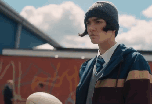 Young Man With Hat Tie Holding Rugby Ball GIF