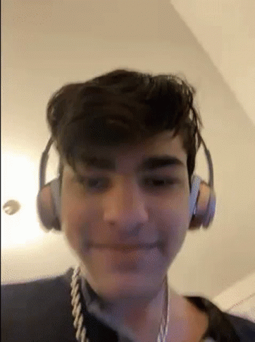 Young Man With Headphones And Rope Around Neck Smiling GIF