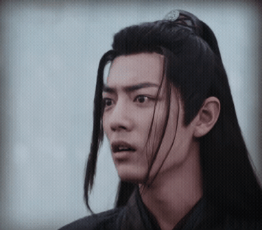 Young Man With Long Black Hair Making Funny Face