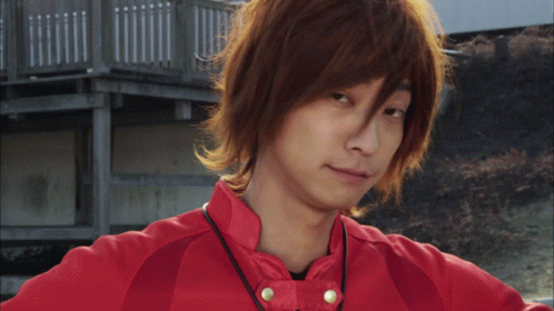 Young Man with Long Brown Hair and Red Jacket