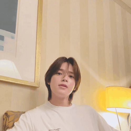 Young Man with Long Brown Hair in White Shirt