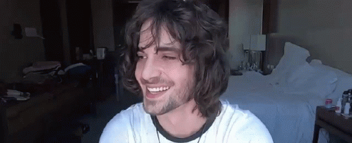 Young Man With Long Curly Hair Smiling