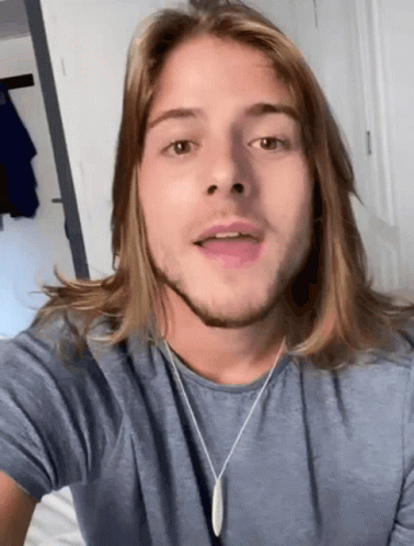 Young Man With Long Hair and Beard in Blue Shirt