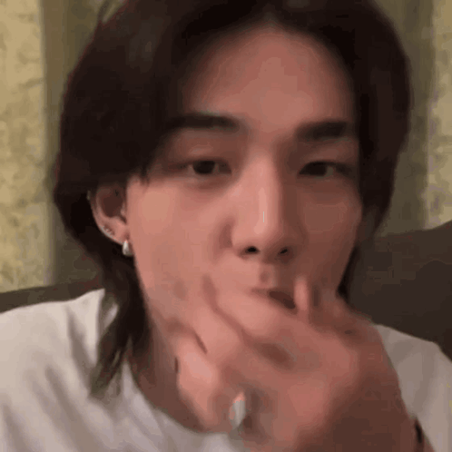 Young Man With Long Hair Eating With Hand