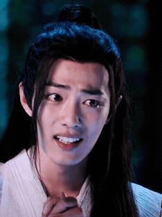 Young Man With Long Hair Making Funny Face GIF