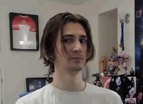 Young Man With Long Hair Standing By Framed Jersey GIF