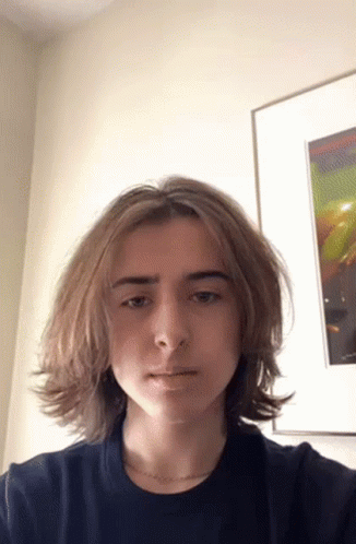 Young Man With Long Hair Taking Selfie