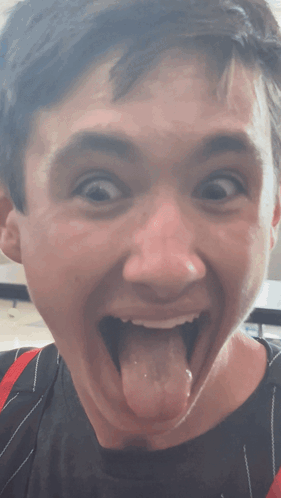 Young Man With Mouth Open and Tongue Out