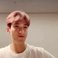 Young Man With Pink Hair in White T-Shirt Looking at Camera