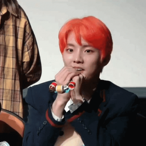 Young Man With Red Hair Holding Toy