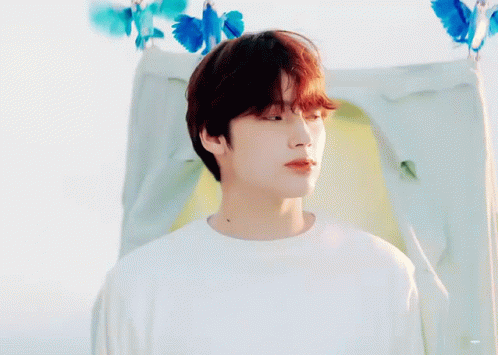 Young Man with Red Hair in Front of Tent with Blue Butterflies