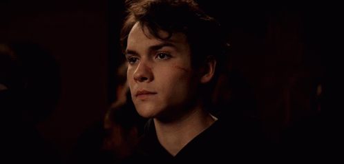 Young Man With Scar on Face Looking Down