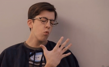 Young Man Yawning With Glasses and Name Tag