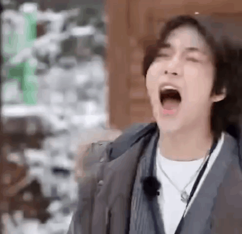 Young Man Yawns in Jacket Necklace