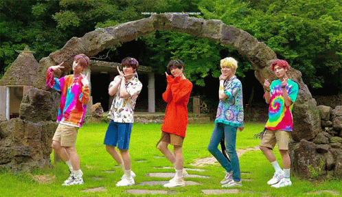 Young Men By Stone Archway In Field GIF
