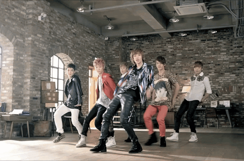 Young Men Dancing in Brick Wall Room