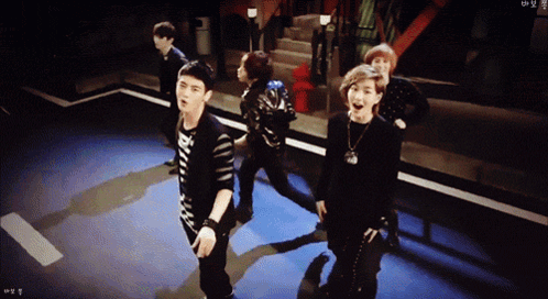 Young Men Dancing In Dark Room With RM Shirt GIF