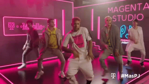 Young Men Dancing in Front of Magenta Sign