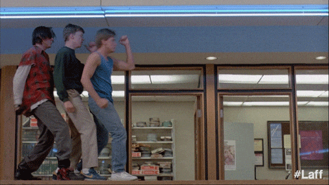 Young Men Dancing in Front of Pizza Hut Sign