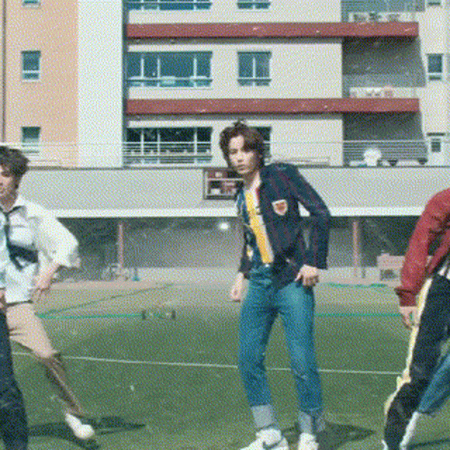 Young Men Dancing On Soccer Field In Front Of Building GIF