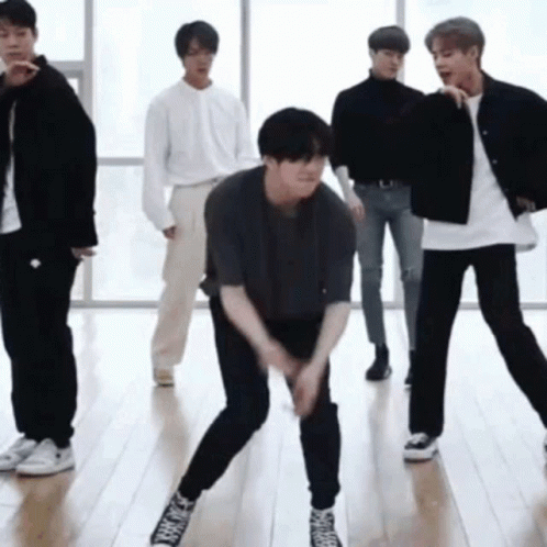 Young Men Dancing on Wooden Floor
