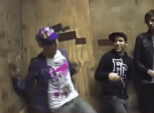 Young Men Dancing One With E Shirt