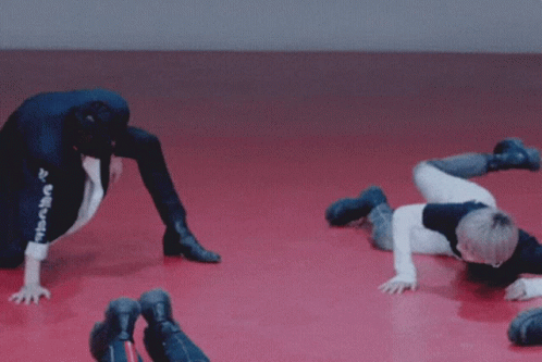 Young Men Doing Handstands on Red Floor Saying Haha
