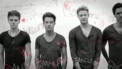 Young Men in Front of Whiteboard Saying He Heart