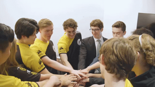 Young Men in Yellow Corsair Shirts Putting Hands Together