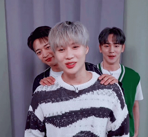 Young Men Posing One In Striped Sweater GIF