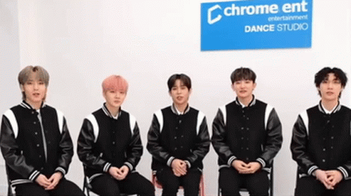 Young Men Sitting in Front of Chrome Ent Sign