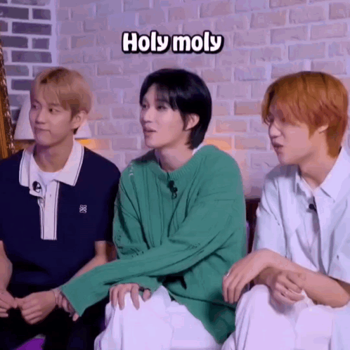 Young Men Sitting Next to Each Other