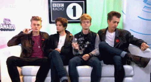 Young Men Sitting on Couch in Front of BBC Radio 1 Sign